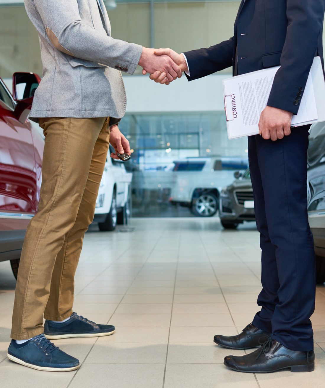 people-shaking-hands-in-car-showroom.jpg